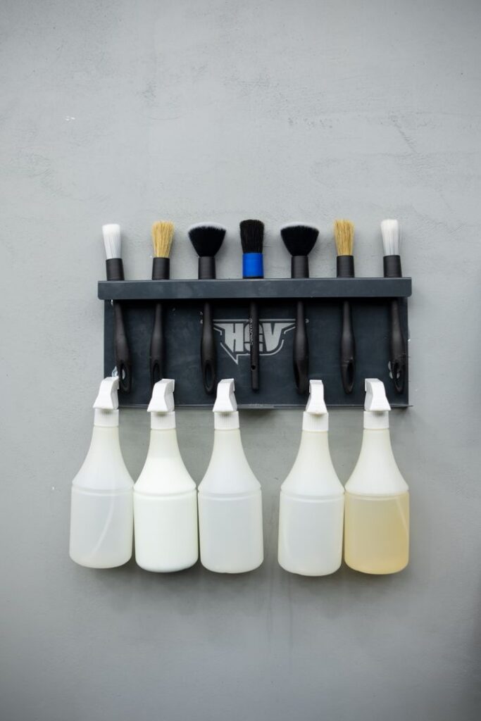 Demo Post 1 Wall-mounted rack with cleaning brushes and spray bottles. Perfect for organization themes.